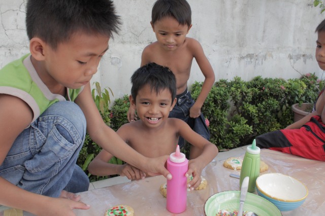 For the last few months, seven year old Jories (far right) has taken home a portion of any snacks and meals he has received at events home for his pregnant mother. While he claims that he's “full”, he is constantly sacrificing to be sure she and his younger sibling are taken care of. Today was no exception. His older brother Jaynier (right) helps RhiJohn and John Kurt decorate theirs without making too big of a mess, and was almost successful. Even on fun days, hard realities follow these kids, yet  they are so unselfish and willing to share.